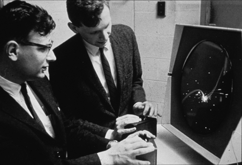 Playing Spacewar! with the control boxes, ca. 1962, Dan Edwards (left) and Peter Samson (right) playing Spacewar!